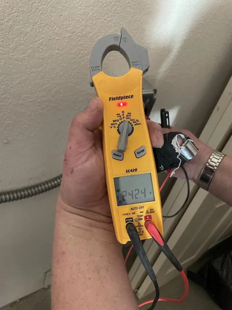 Voltage testing with clamp meter during Outlet Installation in Evansville